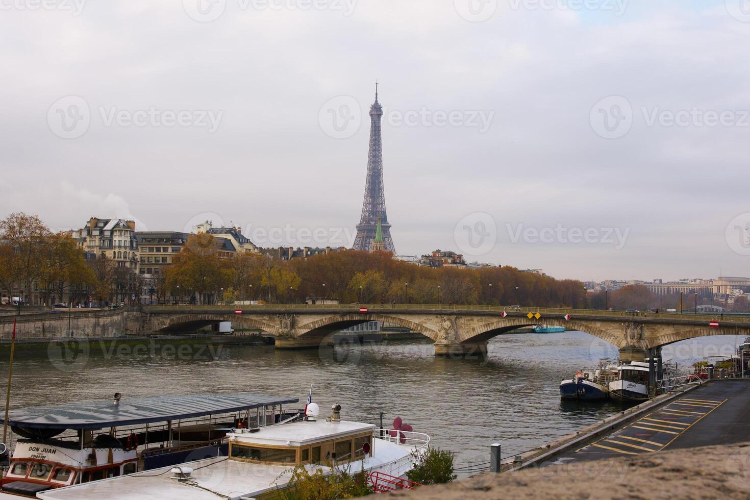 Autumn View of Eiffel Tower and Seine River with Boats and Bridge in Paris photo