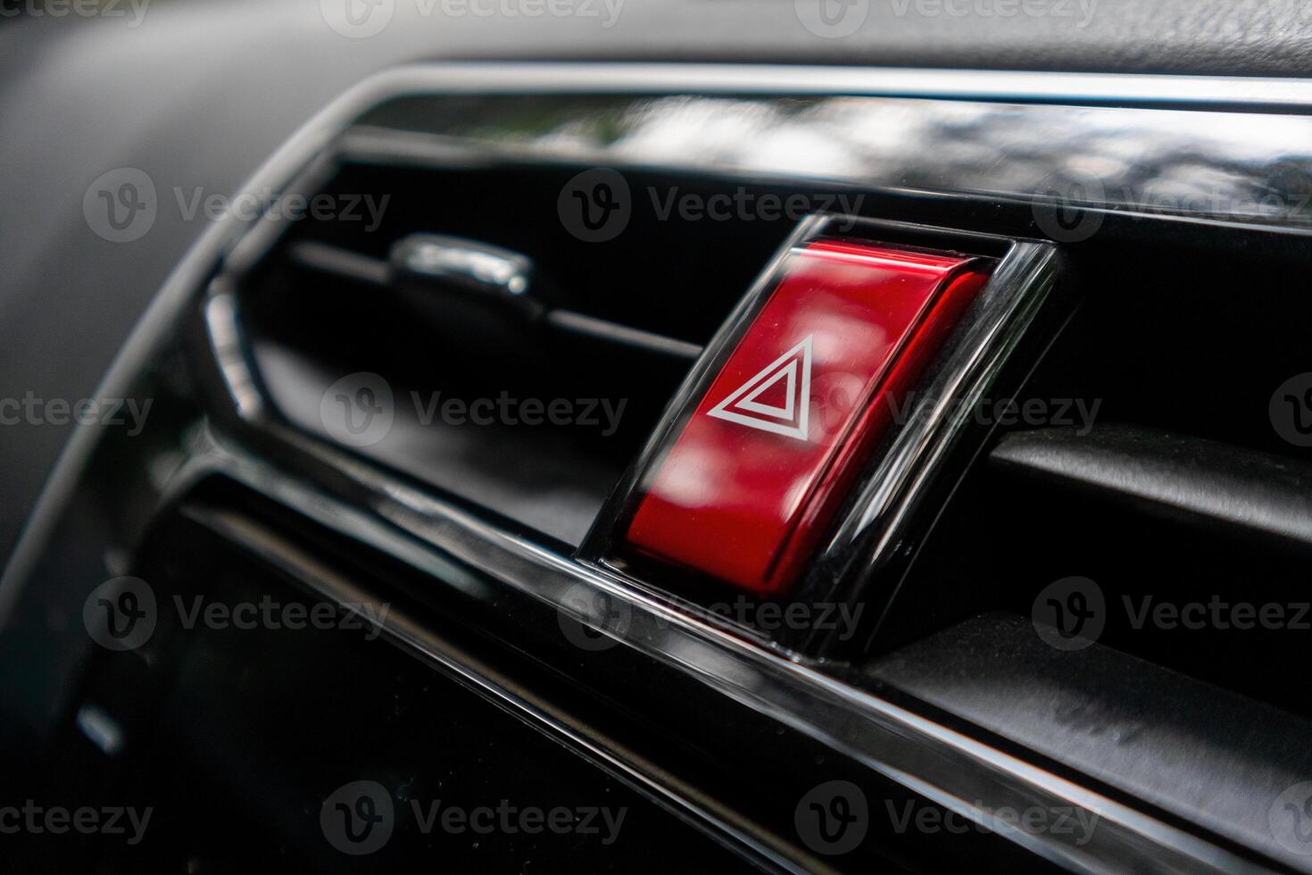Hazard button or emergency warning light button on the car dashboard photo