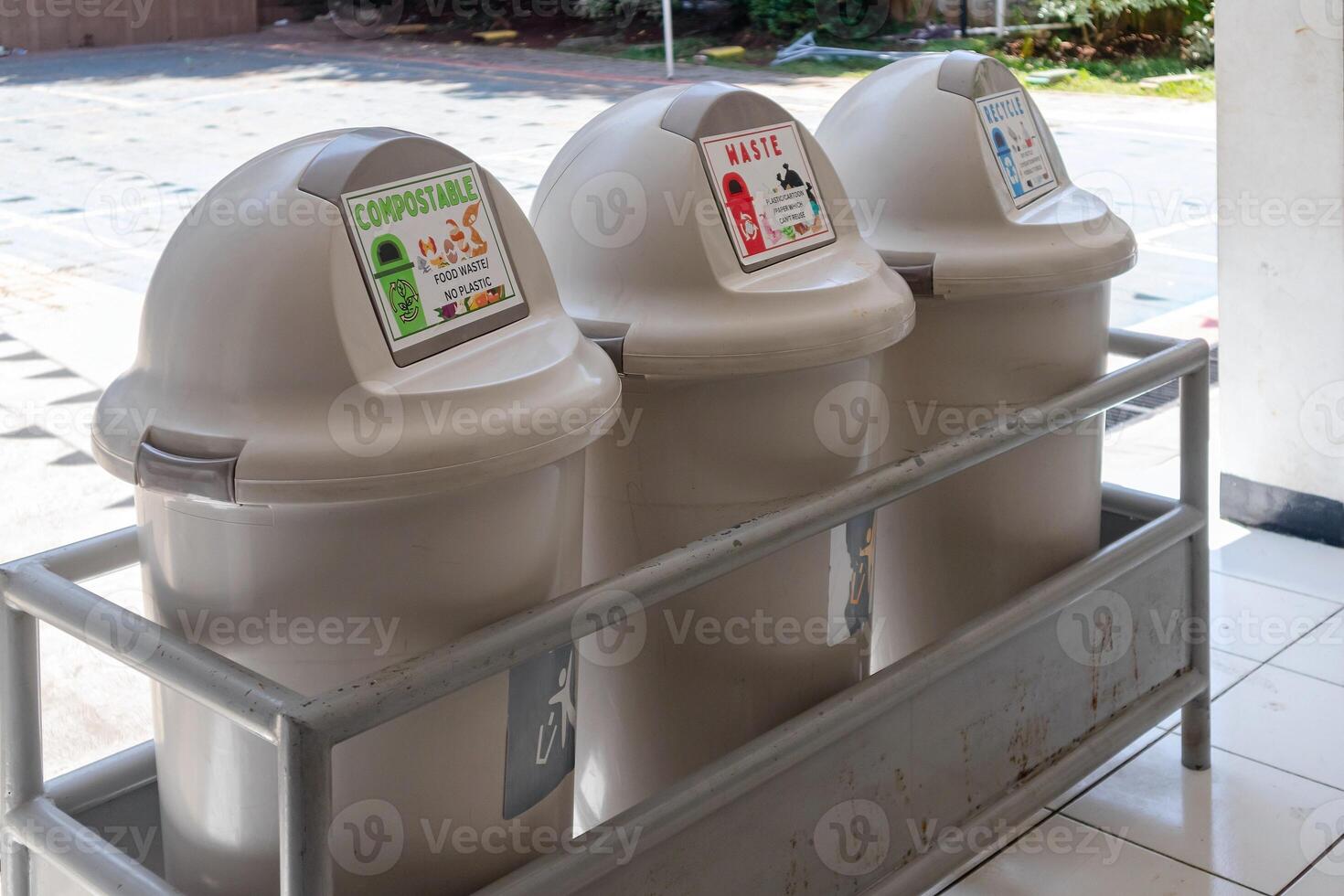 Trash can with three compartments based on categories for recycling at school photo