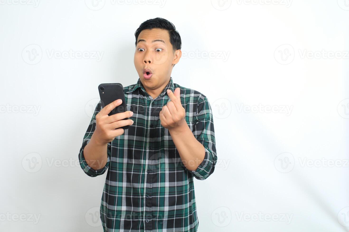asian man surprised looking at smartphone and give hearth shape isolated on white background photo