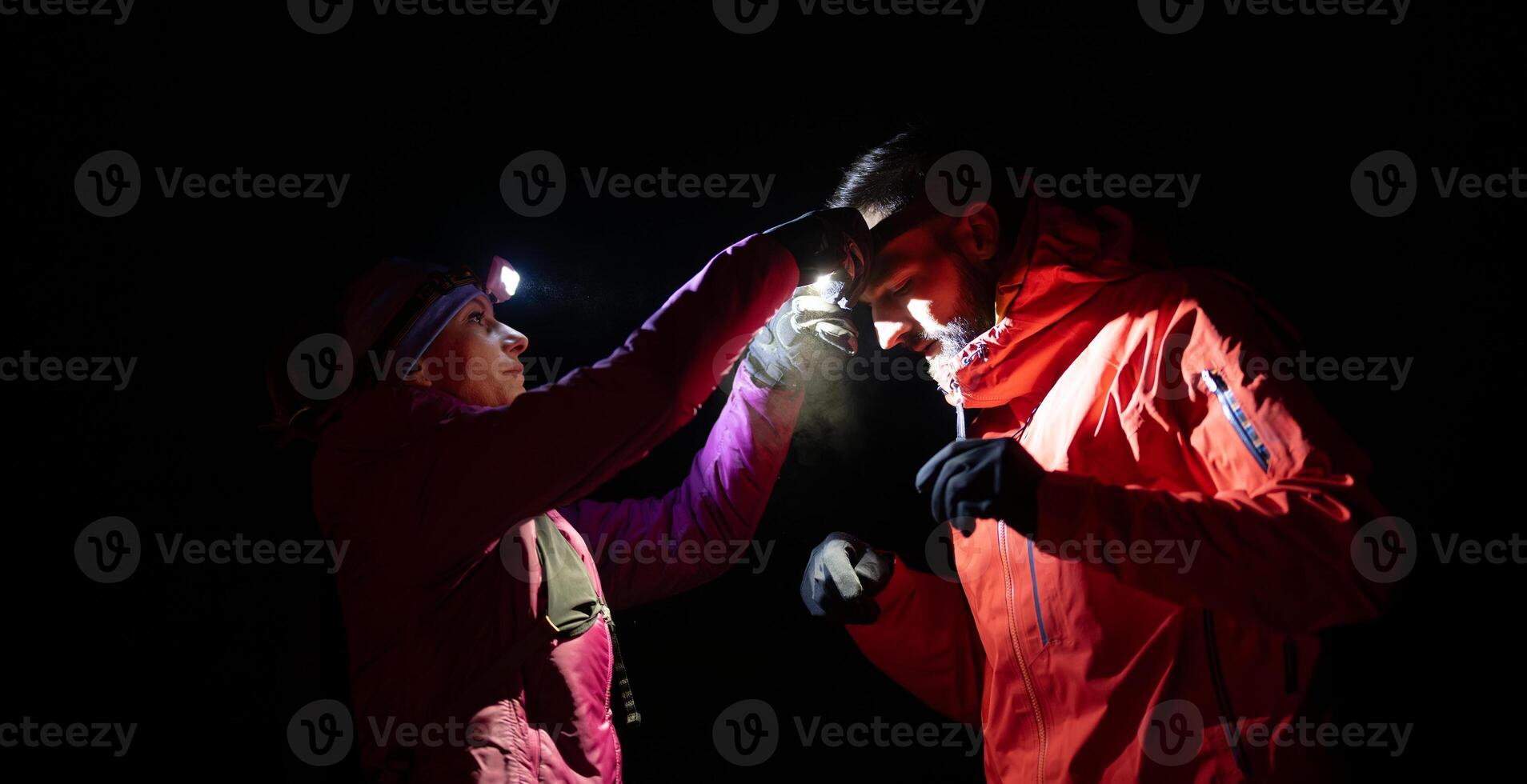 Runners tired of breathing after training look at their tech sports smart watch in night on maintain photo