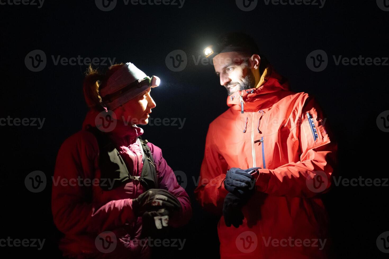 Runners tired of breathing after training look at their tech sports smart watch in night on maintain photo