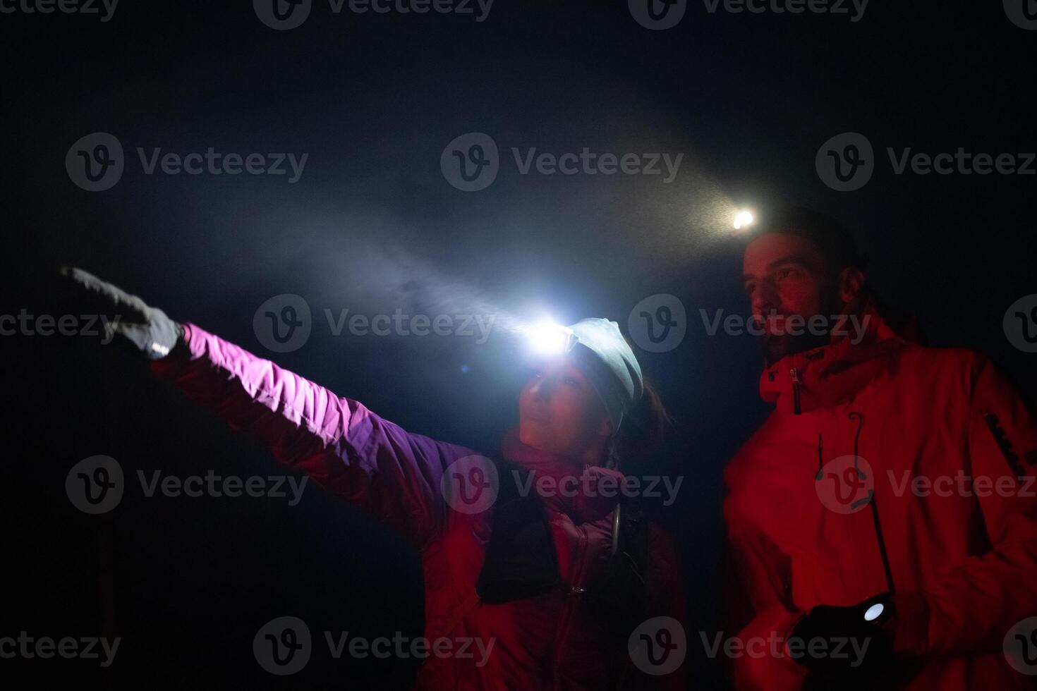 Runners tired of breathing after training look at their tech sports smart watch in night on maintain photo