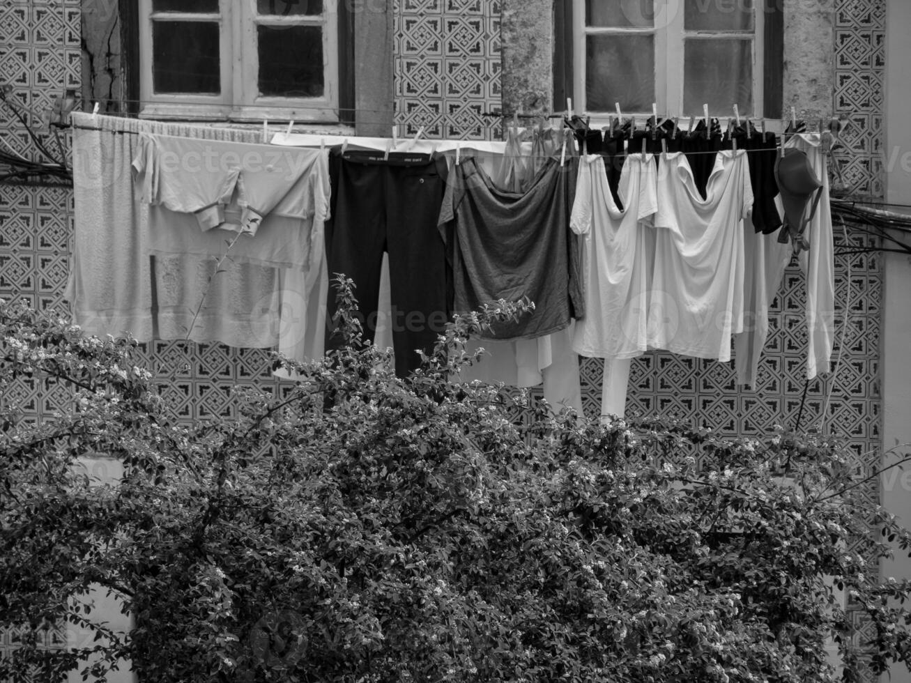 A black and white photo of clothes hanging on a clothes line