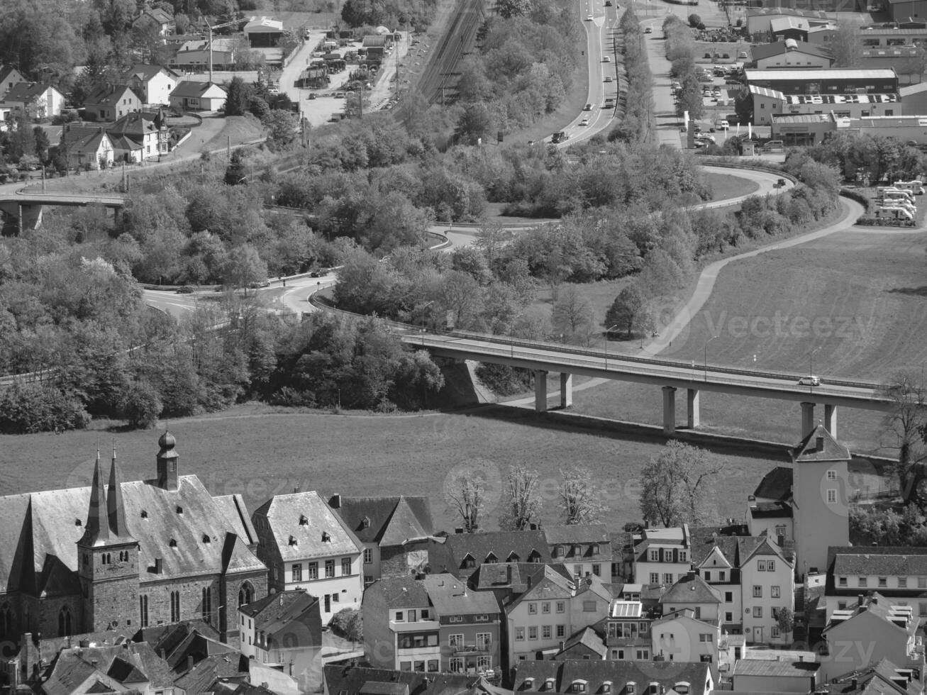 An aerial view of a town with a bridge over it photo