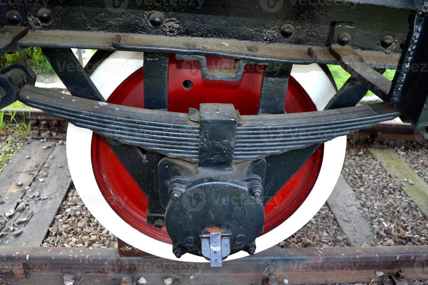 Details of old rusty locomotives close-up, texture. detail Suspension wheels freight wagon. Train machine transport rail way. High quality photo