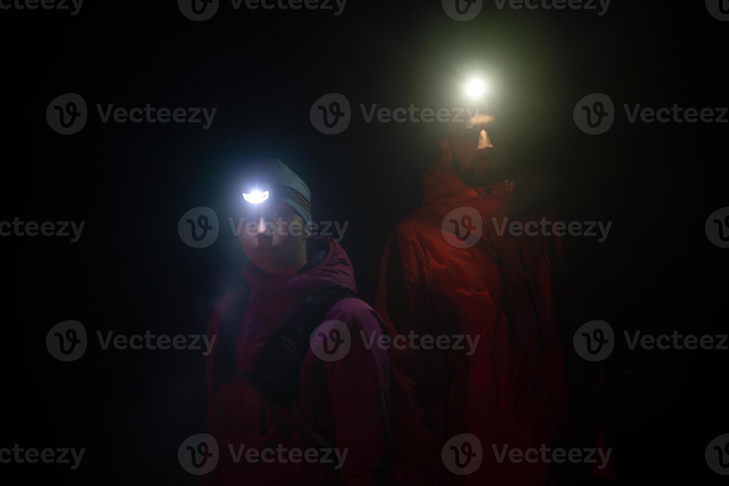 trail runners couple portrait while preparing for an early morning run in the night time with a headlamp photo