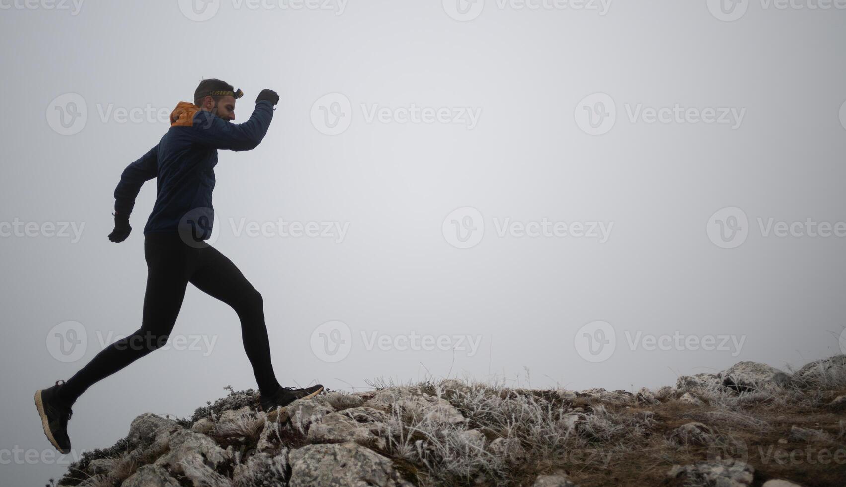 sky running or trail running woman exercising on a mountain top photo