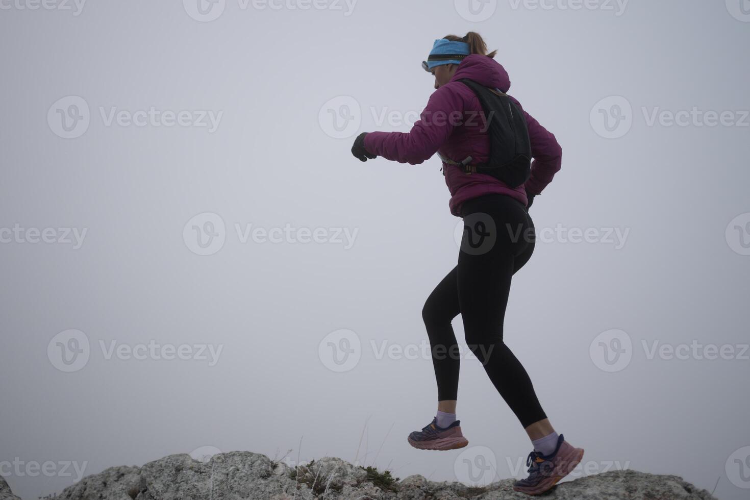 Athlete couple trail running on the mountain top in the early morning. Sky running concept photo