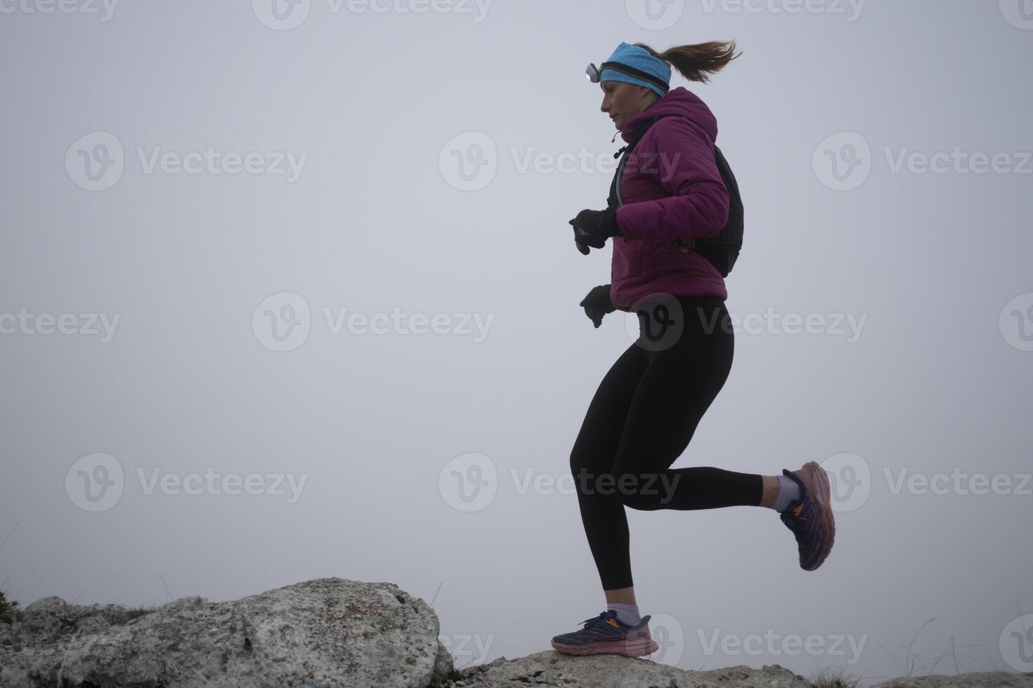 sky running or trail running woman exercising on a mountain top photo