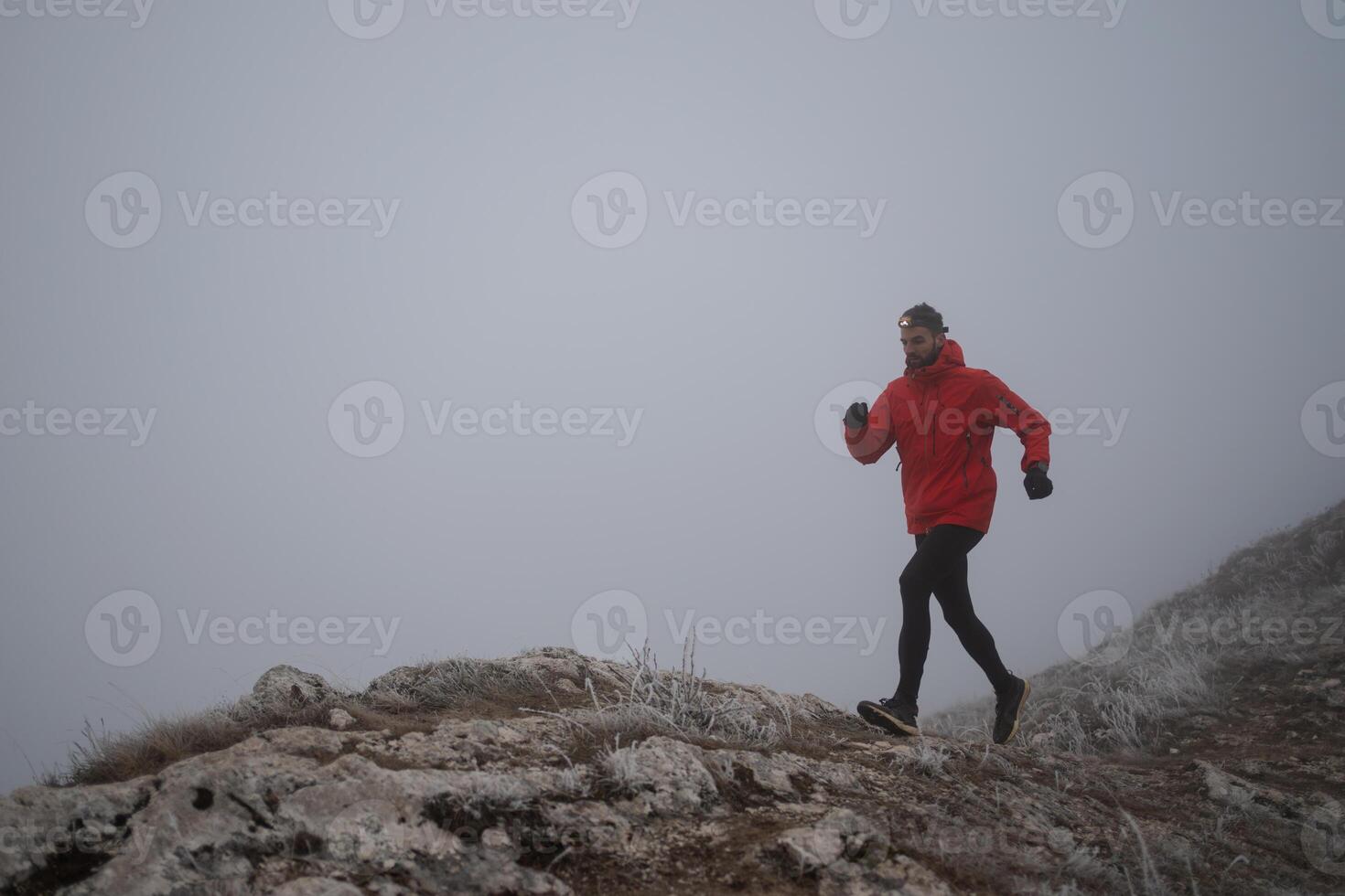 sky running or trail running woman exercising on a mountain top photo