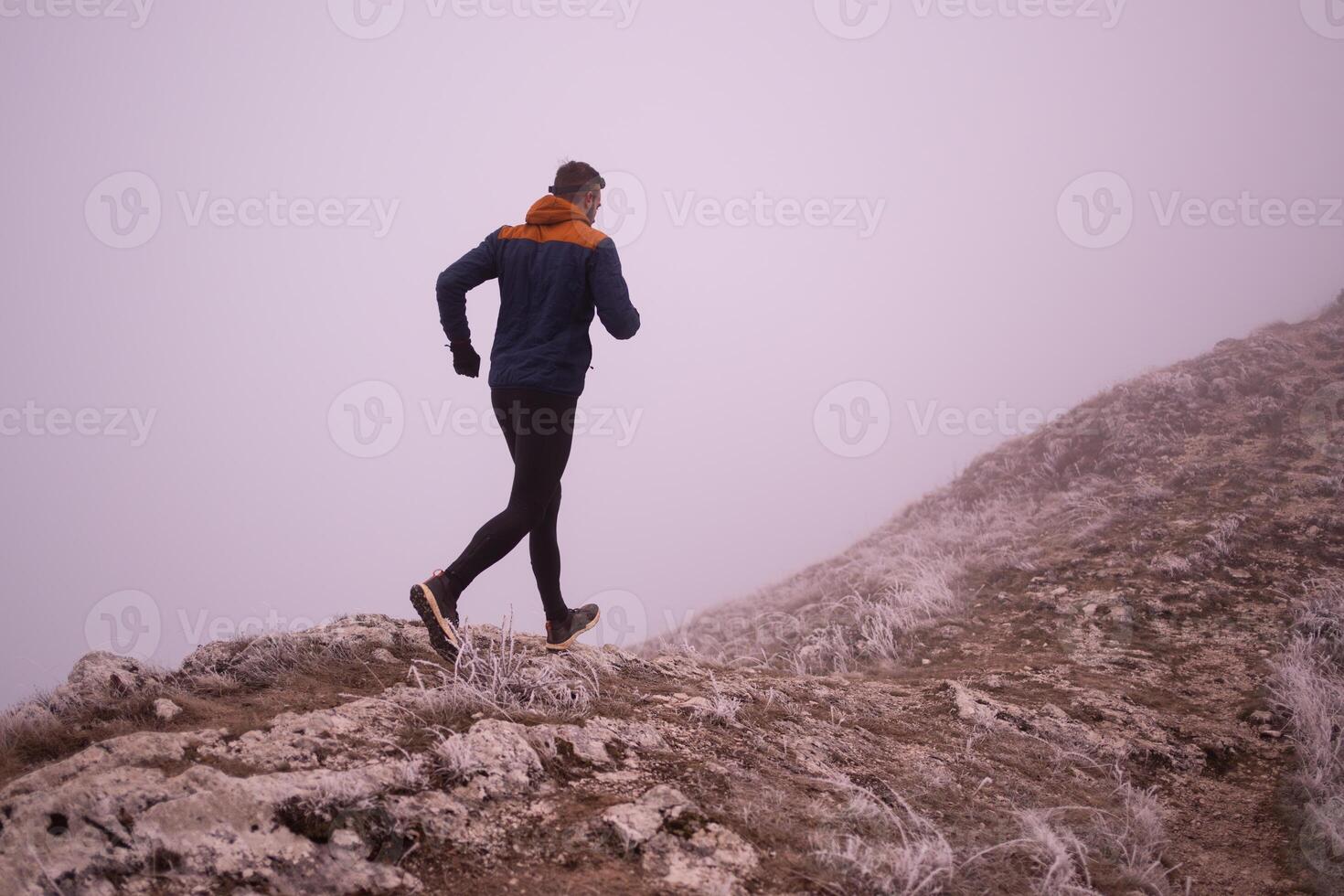 sky running or trail running woman exercising on a mountain top photo