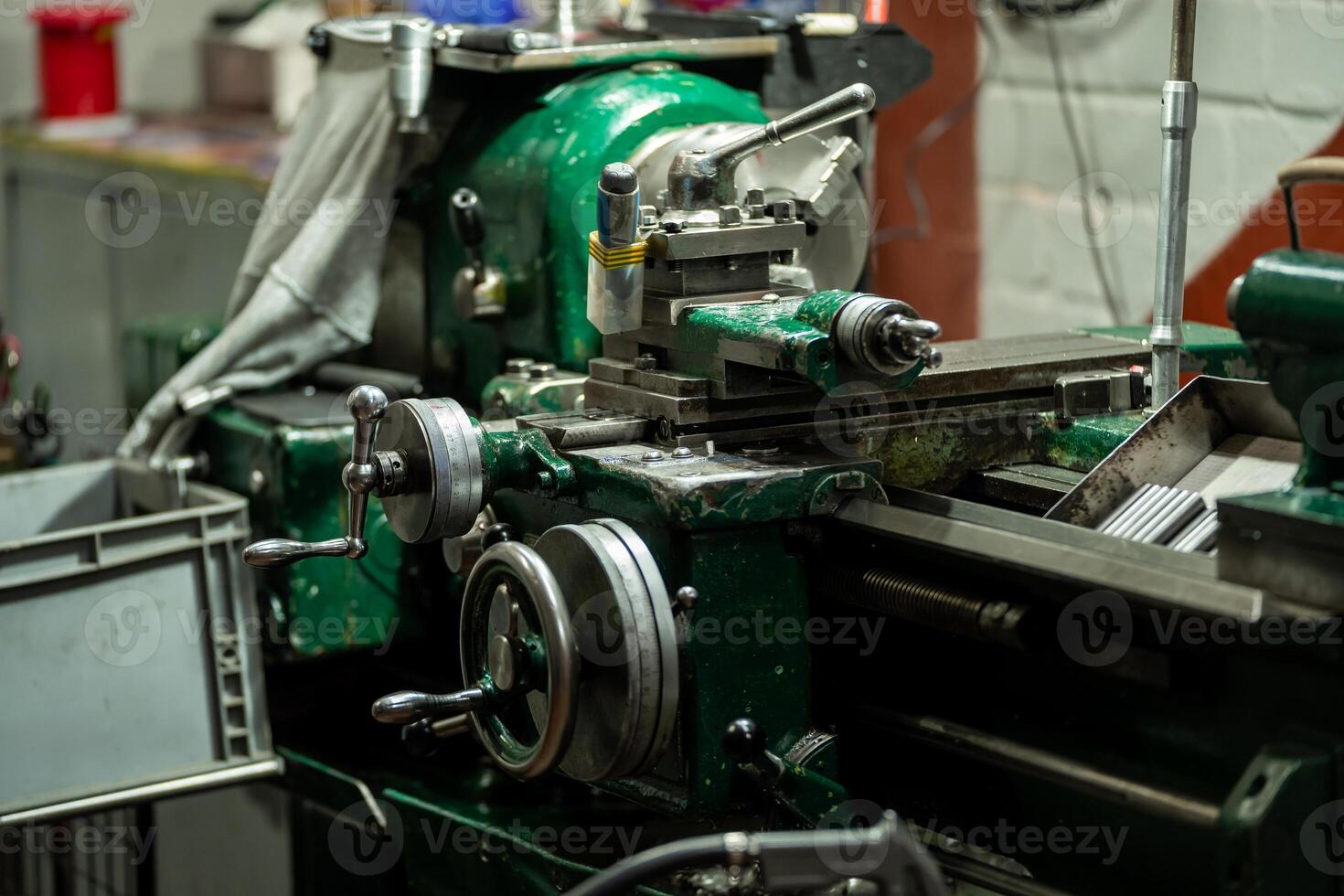 An old, well used lathe machine in a workshop, a vital tool for metalworking and precision engineering tasks. photo