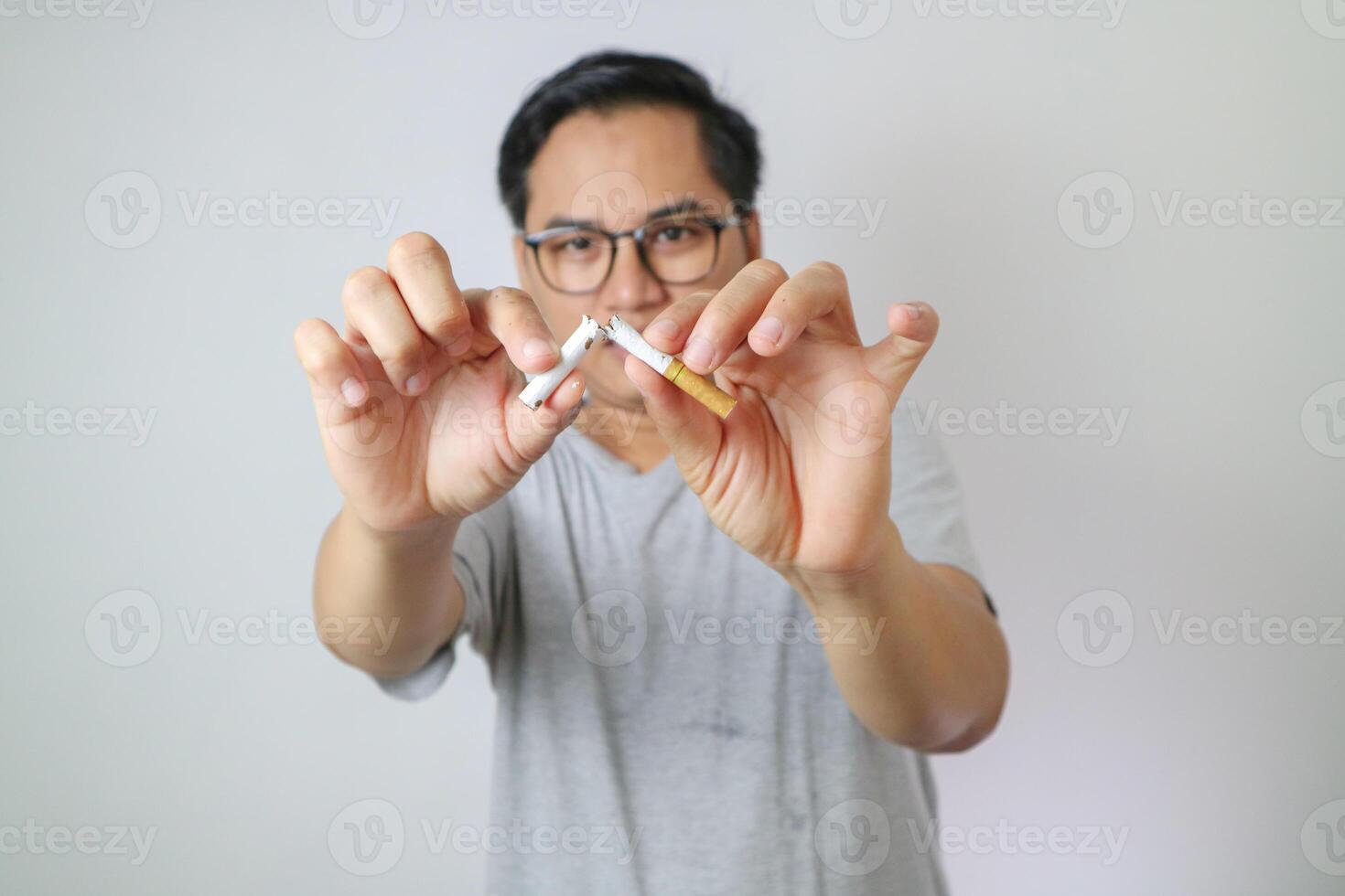 Broken cigarette scattered tobacco with text STOP on a light blue background. Quit smoking concept. stop smoking, World No Tobacco Day. say no. quit smoking for health. drugs, Lung Cancer, emphysema. photo