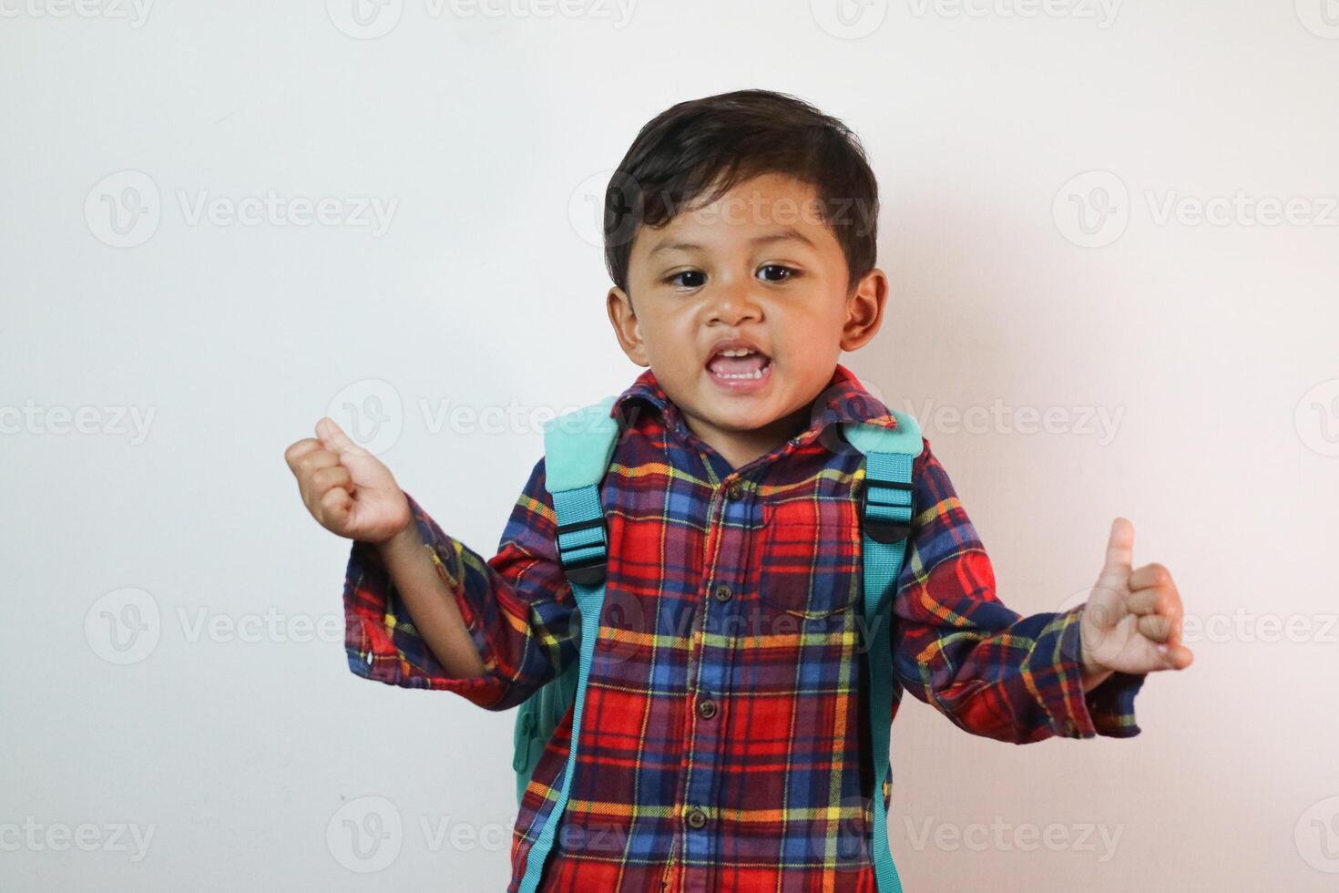 Asian adorable toddler happy pointing finger at copy space in studio shot isolated on white background, Portrait little children boy preschool, Back to school photo