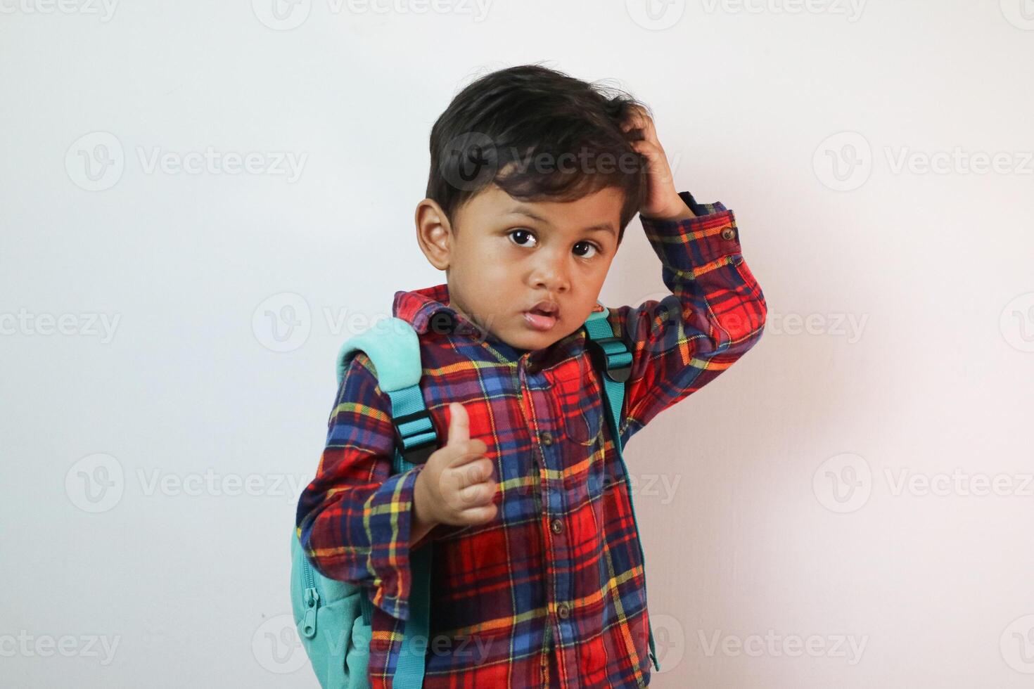 Asian adorable toddler happy pointing finger at copy space in studio shot isolated on white background, Portrait little children boy preschool, Back to school photo