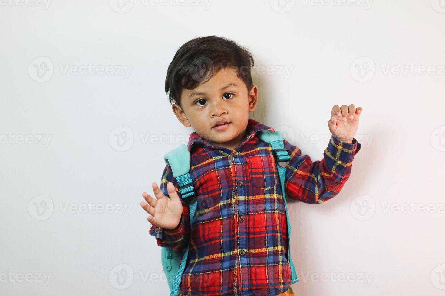 Adorable Asian toddler happily raising hands on copy space in studio shot isolated on white background, Portrait of little preschool children, Back to school photo