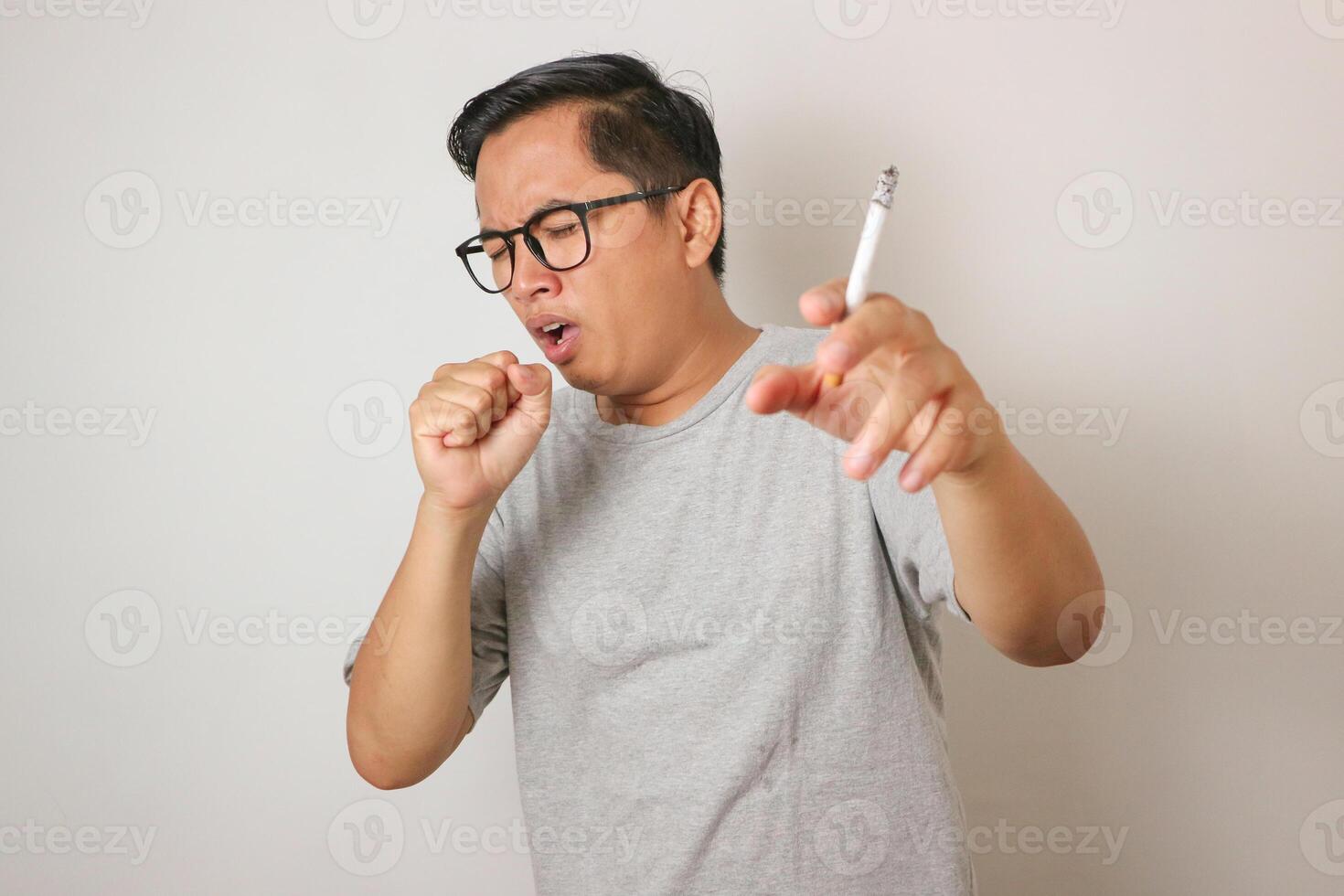 closeup Asian men coughing from smoking cigarette. photo