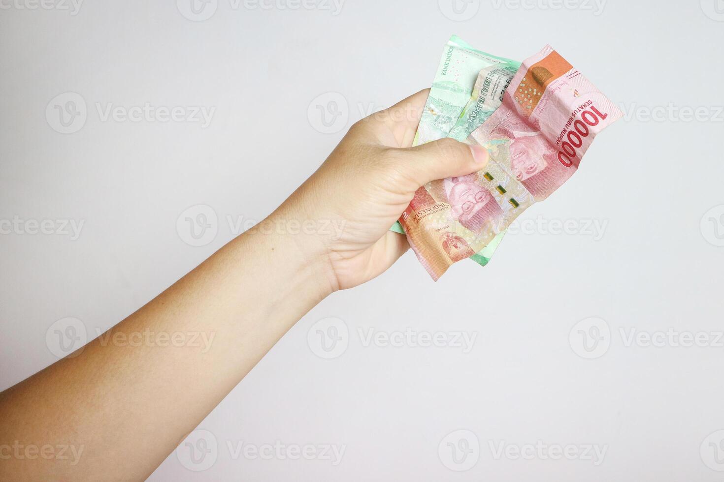 left hand gives crumpled money isolated on white background photo