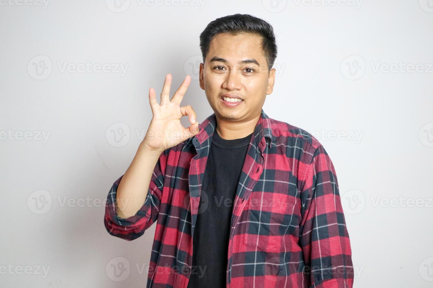 Expression of cheerful confident asian man have all under control, wink encouraging and show okay gesture, approve plan, congratulating person, saying well done, rate excellent job, standing purple b photo