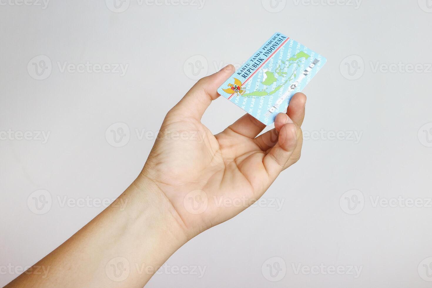 hand holding Indonesian identity cards or E-KTP Kartu Tanda Penduduk owned by Indonesian citizens photo