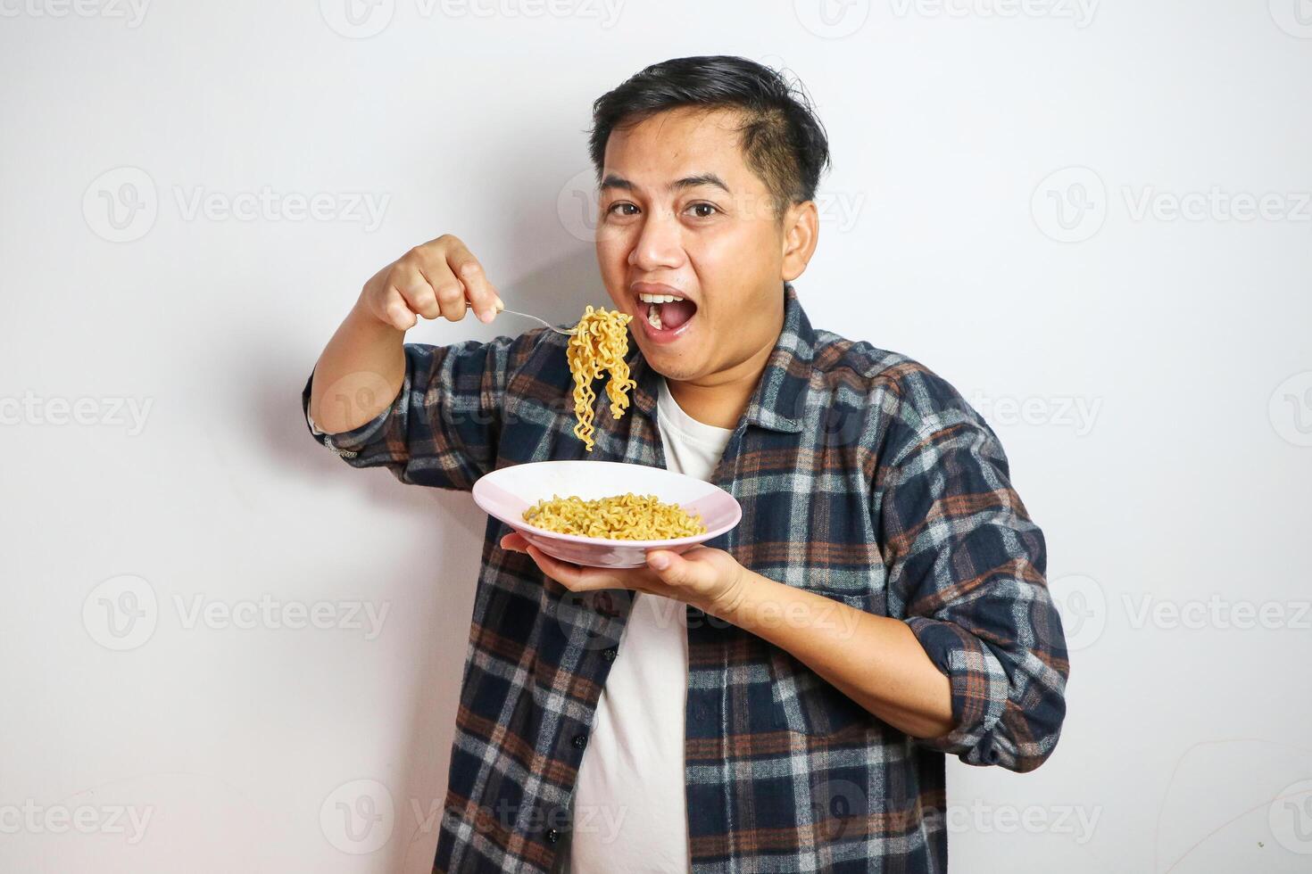Wow and surprised funny face of Asian man eat instant noodle. photo