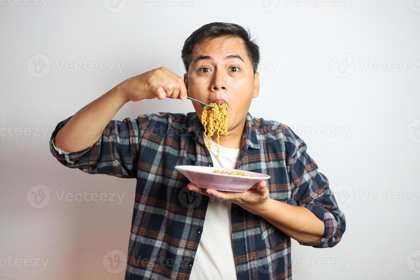 Wow and surprised funny face of Asian man eat instant noodle. photo