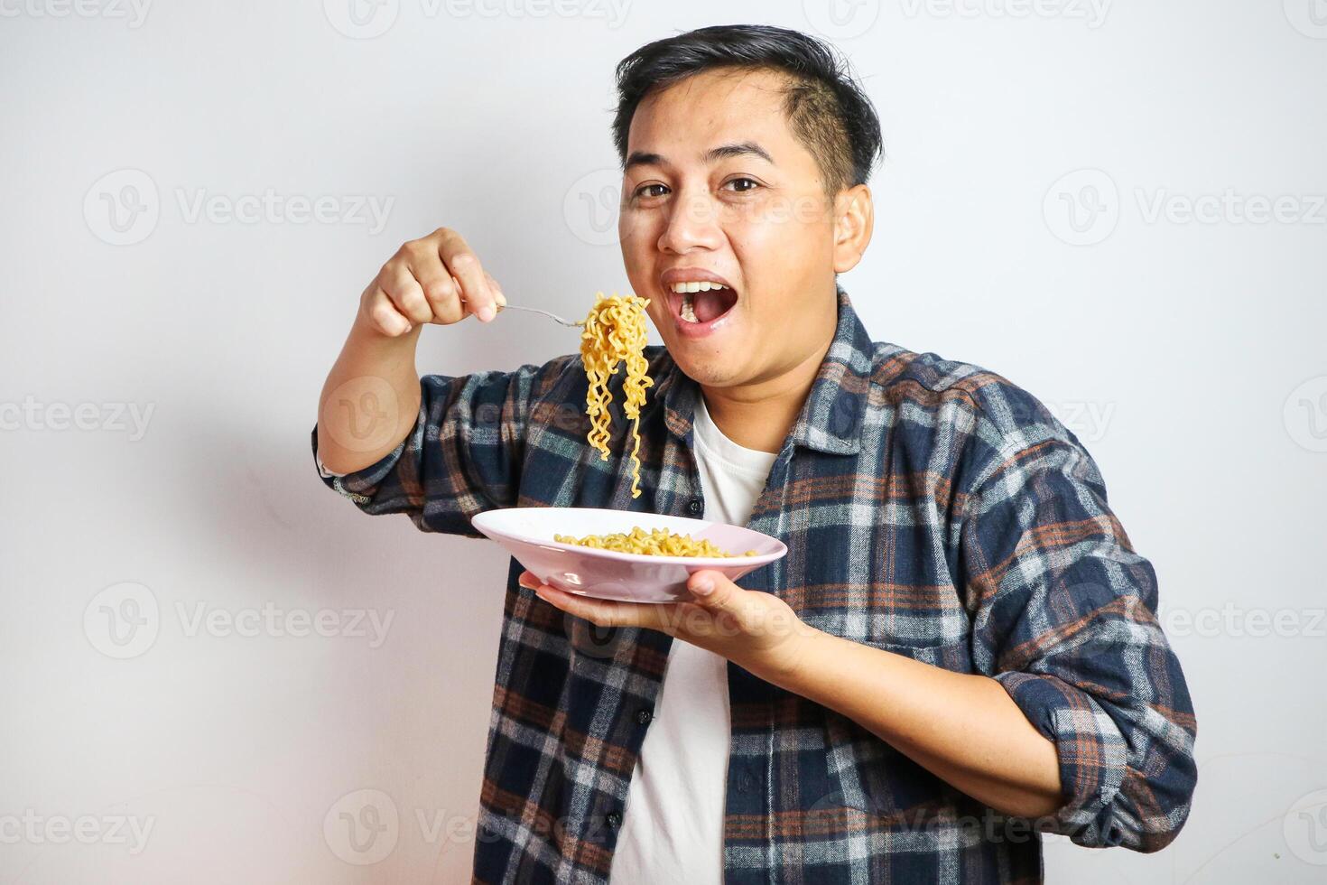 Wow and surprised funny face of Asian man eat instant noodle. photo