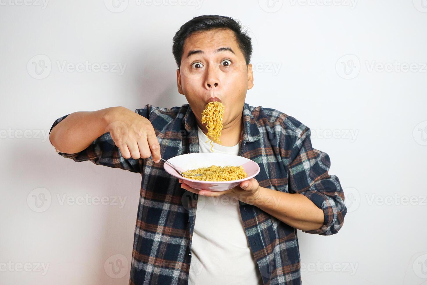 Wow and surprised funny face of Asian man eat instant noodle. photo