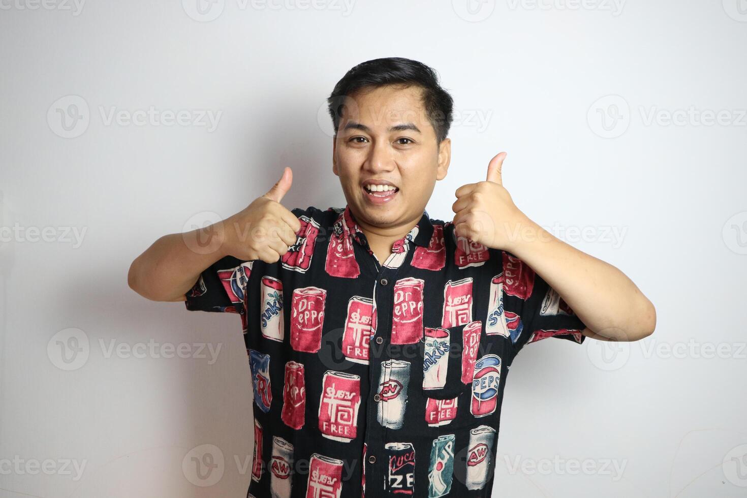 Young asian man wearing casual beach style shirt over white background approving doing positive gesture with hand, thumbs up smiling and happy for success. Winner gesture. photo