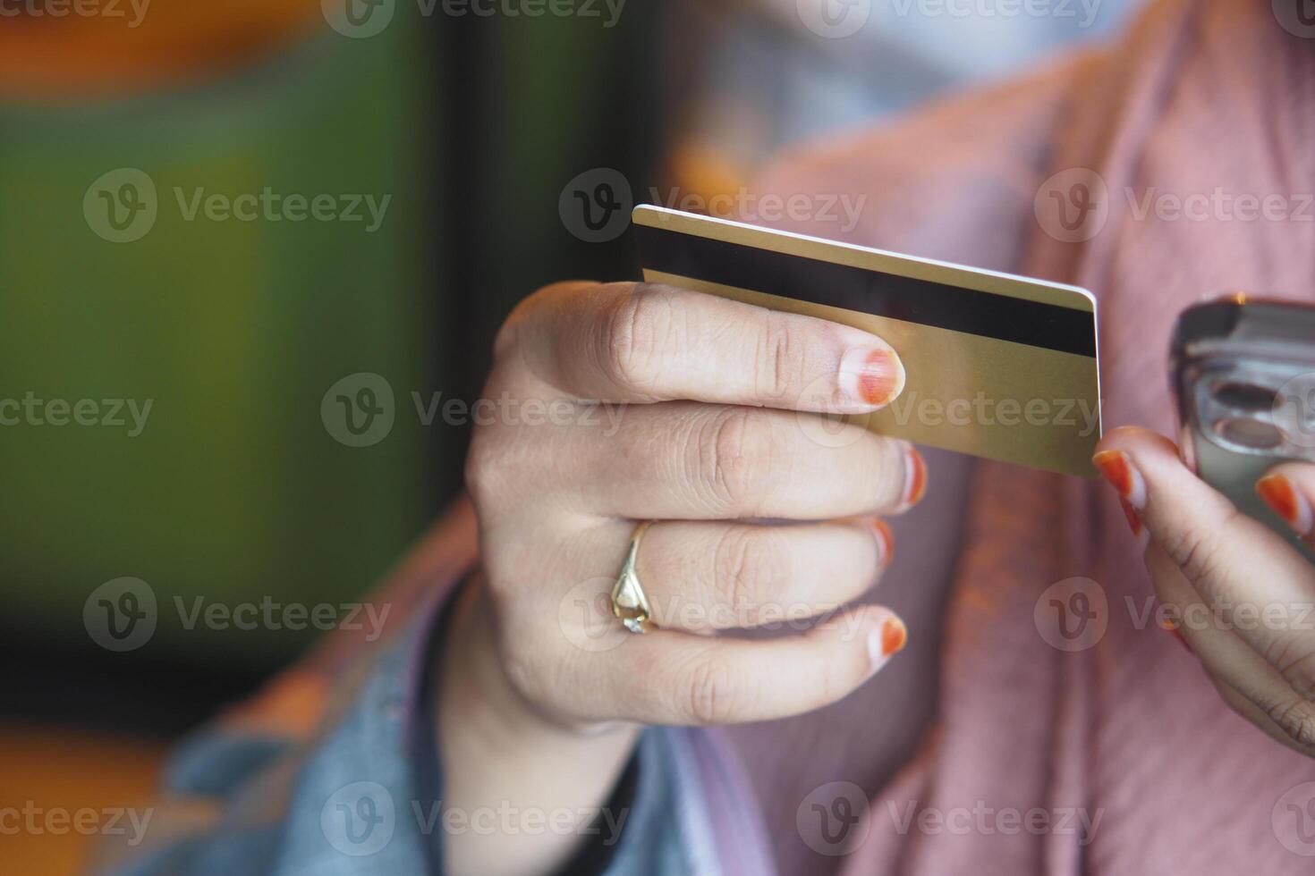 women hand holding credit card and using smart phone shopping online photo
