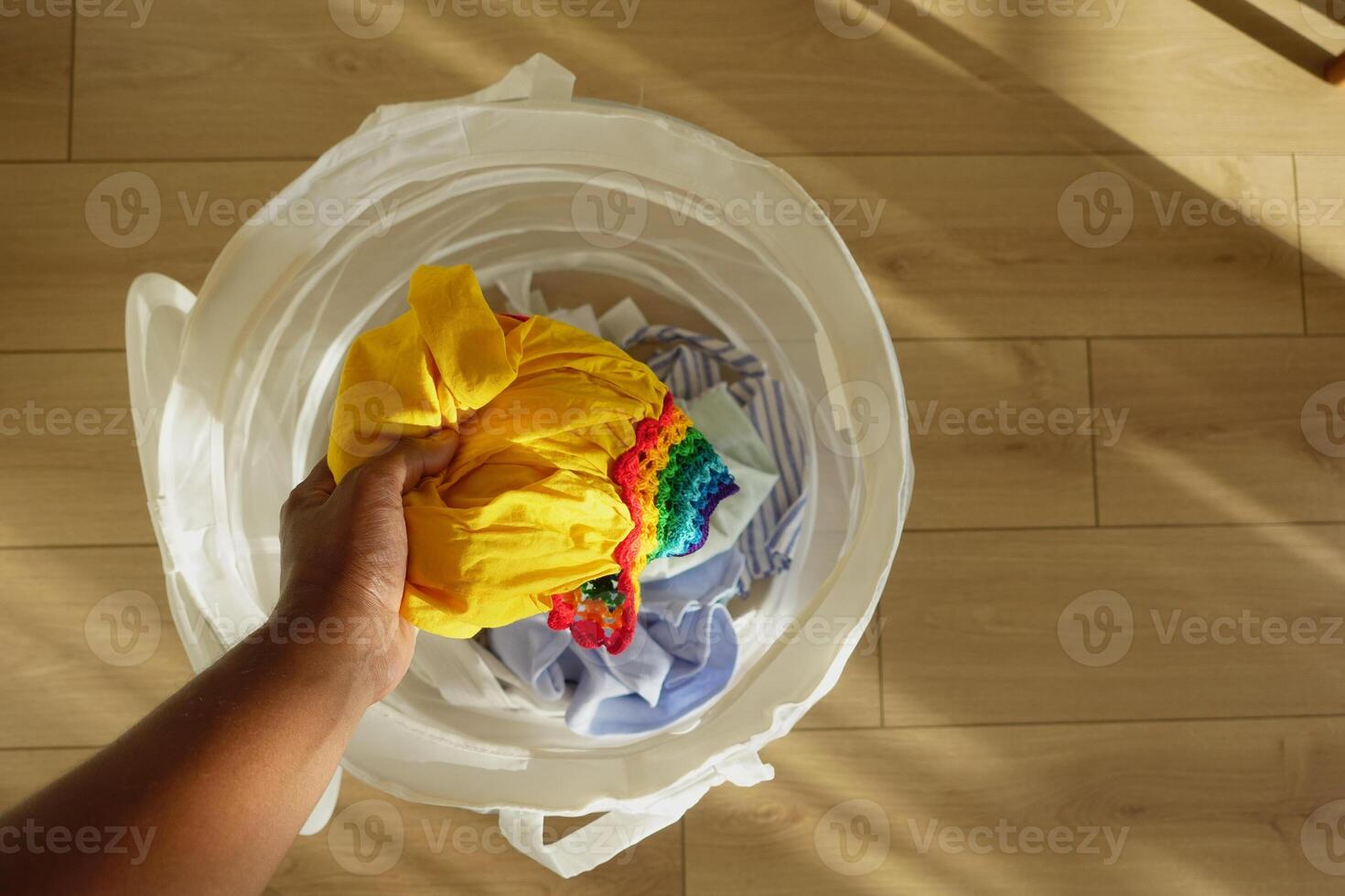A Vibrant Laundry Basket Filled with Colorful Clothes Ready for Washing and Cleaning photo