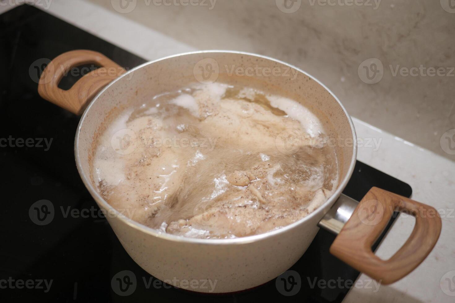 Boiling Chicken in a Pot for Cooking Delicious Homemade Meals with Nutritious Ingredients photo