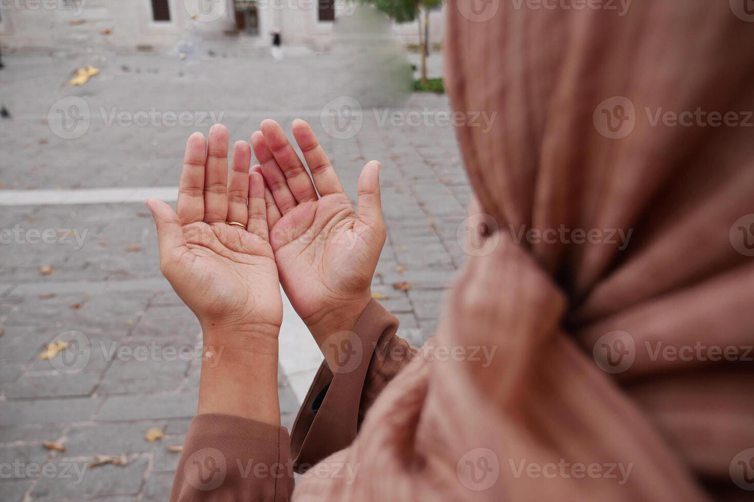 Muslim young woman in hijab is praying in mosque. photo