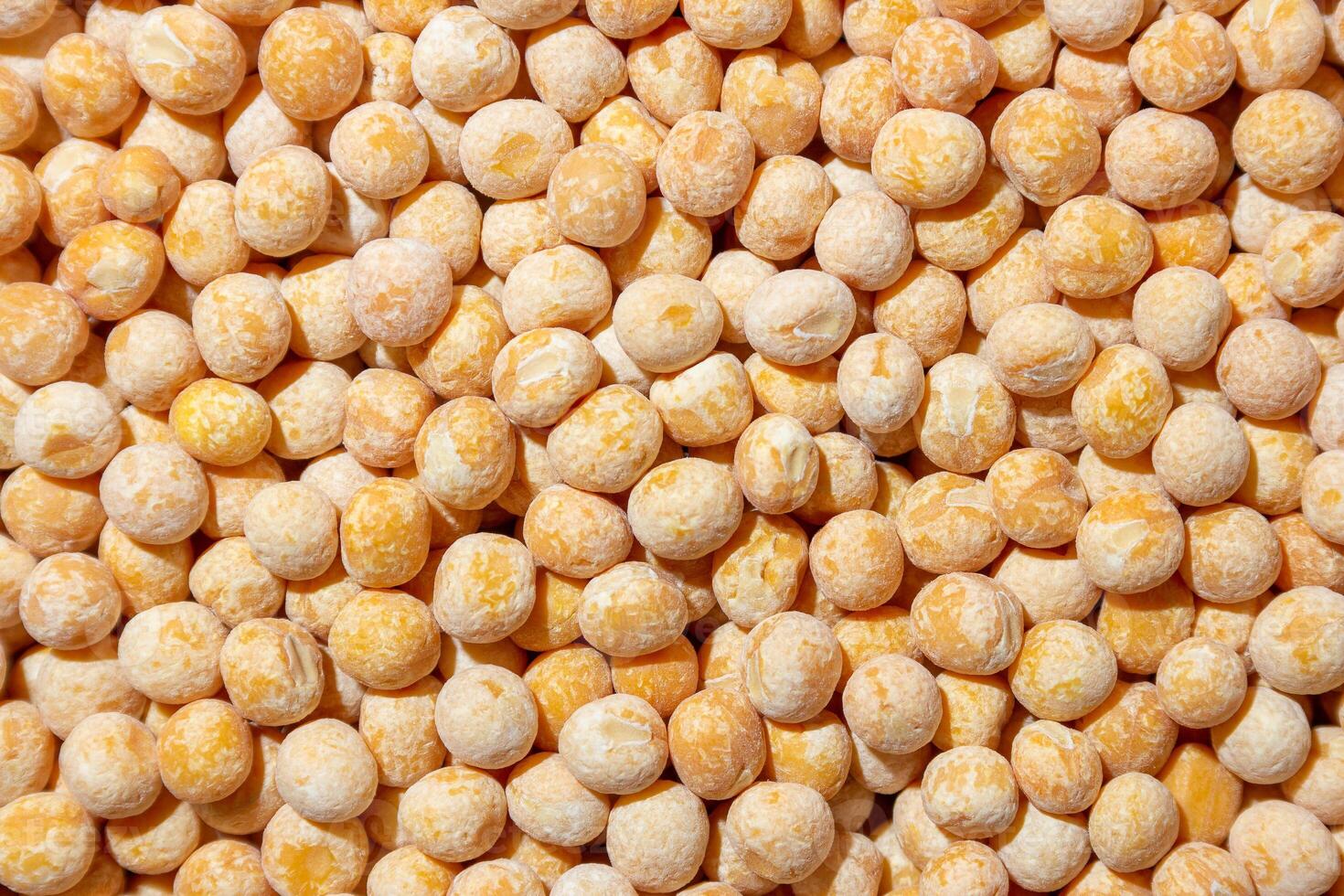 Uncooked Yellow Polished Peas Background. A Culinary Canvas of Dry Yellow Peas, Creating a Lively and Textured Background for Gourmet Cooking. Scattered Raw Polished Peas. Healthy Eating Ingredients photo