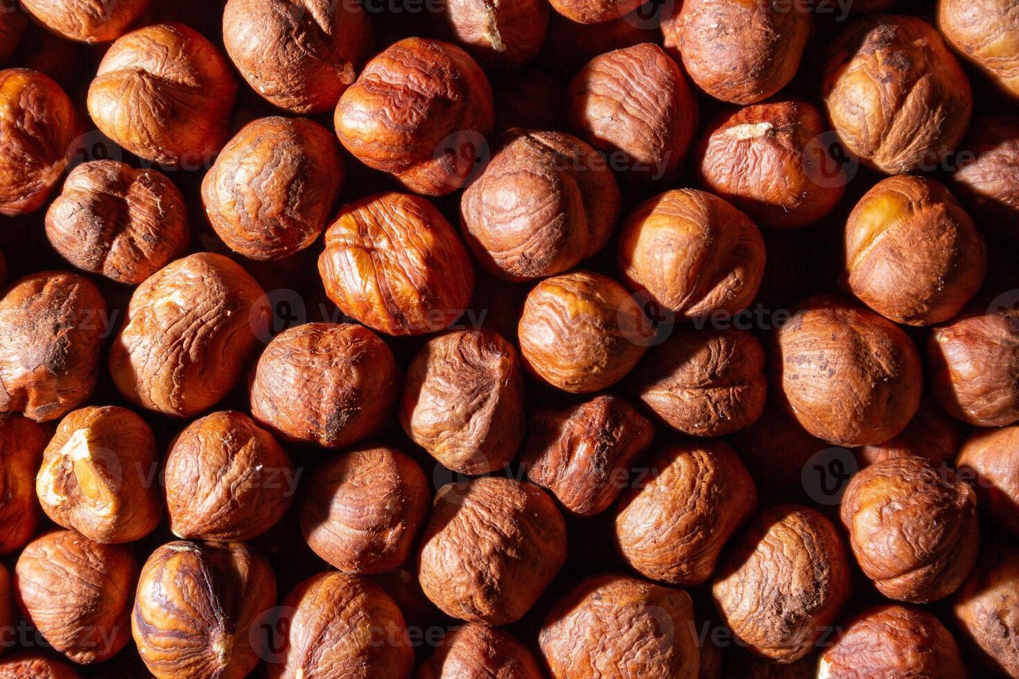 Scattered Peeled Hazelnut - Top View. Background from Hazelnuts. Natural High-Calorie Snacks photo