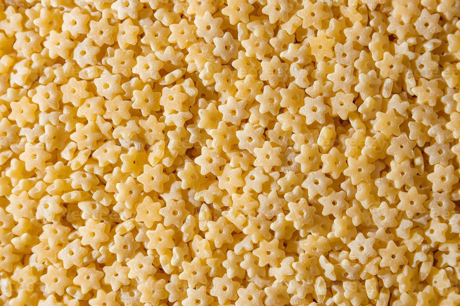 Uncooked Stelline Pasta. A Culinary Canvas of Stelline Macaroni, Creating a Lively and Textured Background for Gourmet Cooking. Dry Pasta. Raw Macaroni - Top View, Flat Lay photo