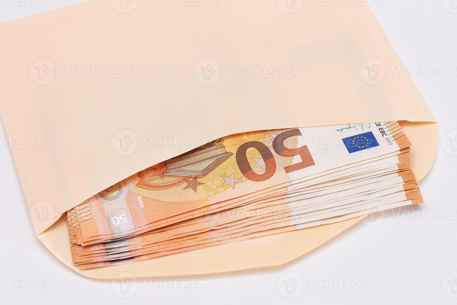 An Orange Paper Envelope with Stack of 50-Euro Banknotes Inside. Salary in Cash. Tax-Free System. Euro Currency. Payments with No Taxes. Orange Paper Money. A Lot of Fifty-Euro Bills photo