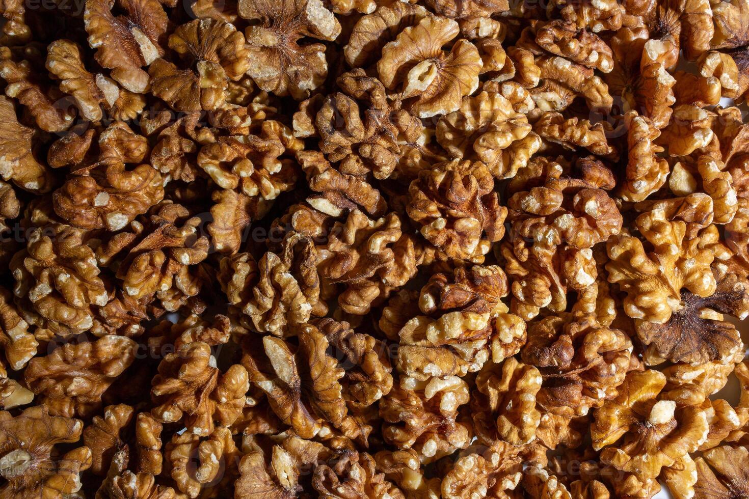 Scattered Shelled Walnuts. Background from Walnut. Natural High-Calorie Snacks photo