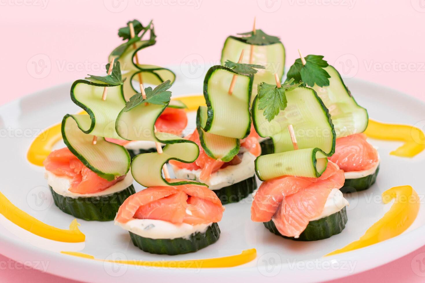 Canapes without Bread with Fresh Salmon, Cucumber and Cream Cheese on White Plate. Easy Breakfast. Diet Food. Quick and Healthy Sandwiches. Healthy Snacks with Tasty Fillings photo