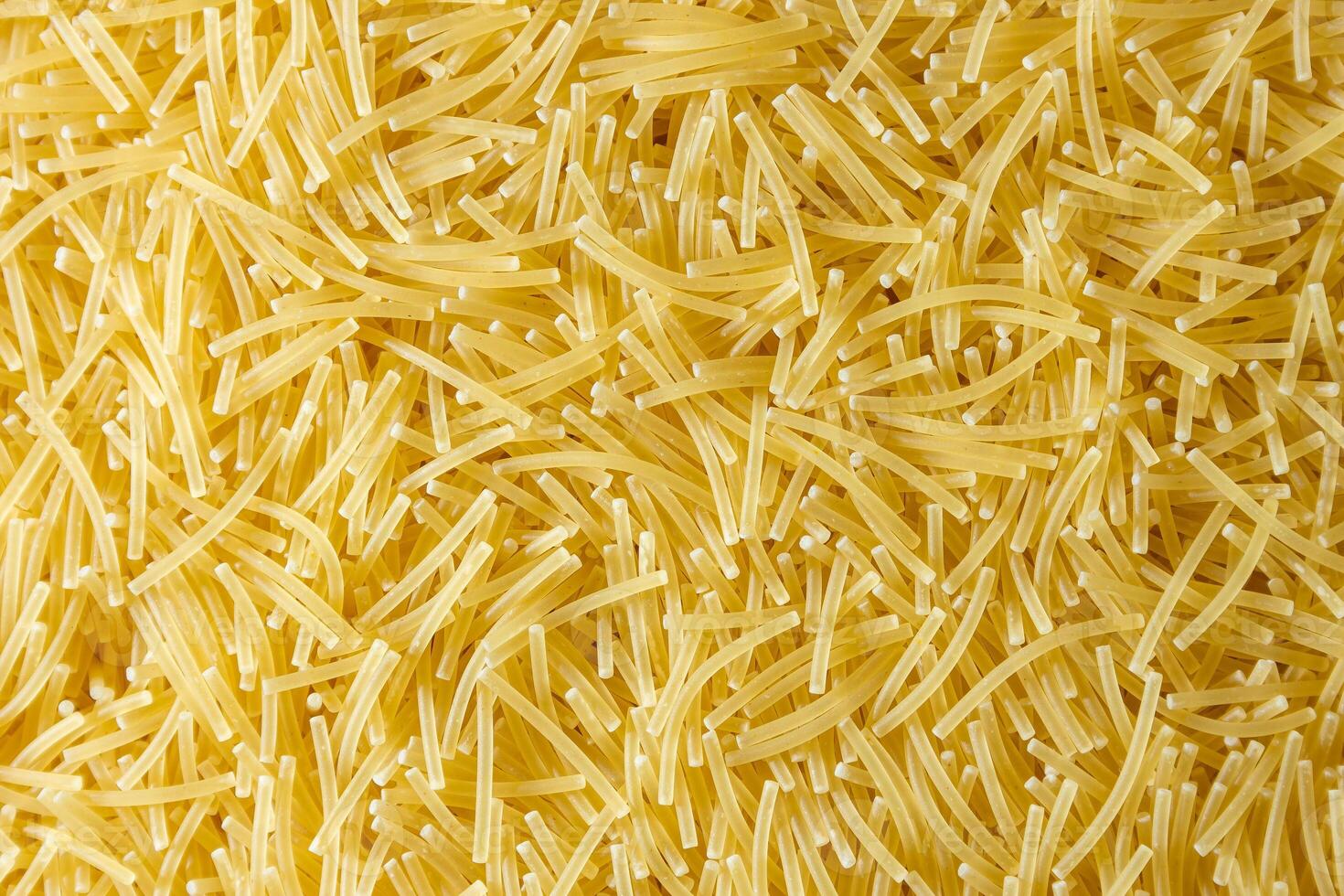 Uncooked Filini Pasta. A Culinary Canvas of Noodles, Creating a Lively and Textured Background for Gourmet Cooking. Dry Pasta. Raw Macaroni - Top View, Flat Lay photo