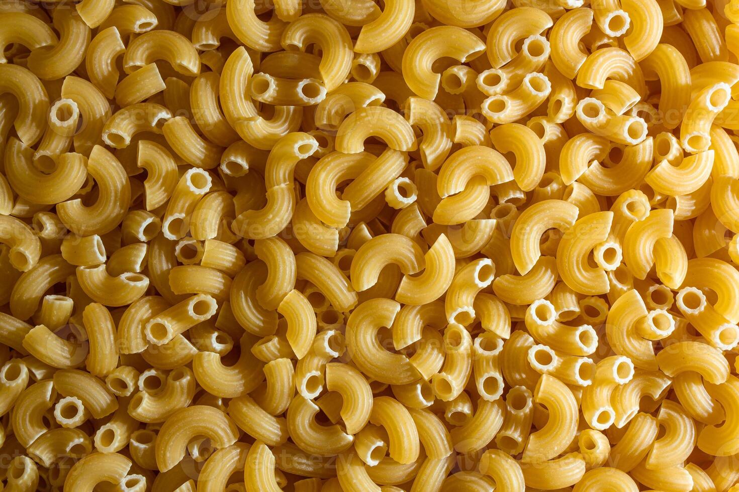 Uncooked Chifferi Rigati Pasta. A Culinary Canvas of Chifferi Rigati, Creating a Lively and Textured Background for Gourmet Cooking. Dry Pasta. Raw Macaroni - Top View, Flat Lay photo
