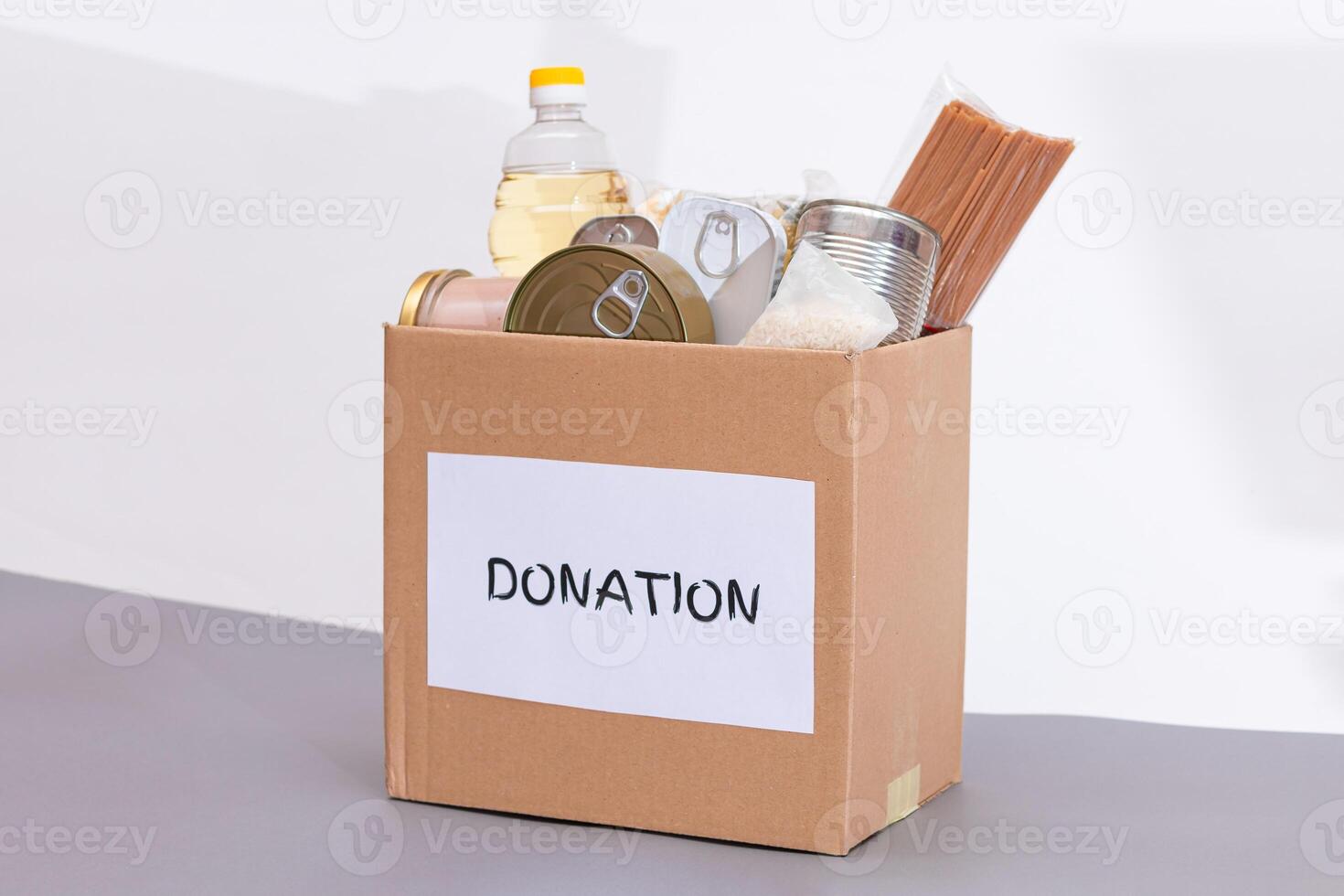 Donation Box of Free Food. Carton Box with Canned Food, Cereals and Grocery. Meal Reserves. Emergency Food Storage in Case of Crisis. Free Social Help, Blessings and Care. Strategic Food Supplies photo
