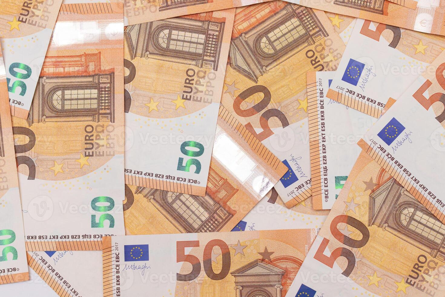 50 Euro Banknotes Money Background. Euro Money Currency. Orange Paper Money. A Lot of Fifty Euro Bills. Business, Finances, Cash and Money Saving Concept photo