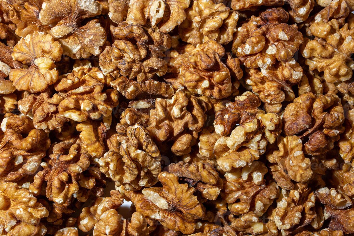 Scattered Shelled Walnuts. Background from Walnut. Natural High-Calorie Snacks photo