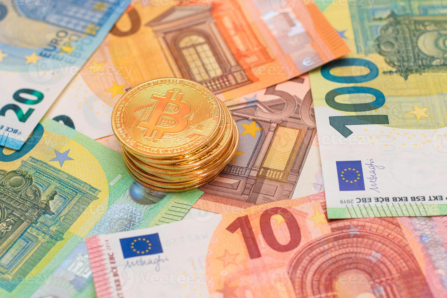 A Stack of Bitcoin Coins on the Euro Banknotes. Money Saving, Cryptocurrency, Blockchain and Anonymous Payments Concept photo