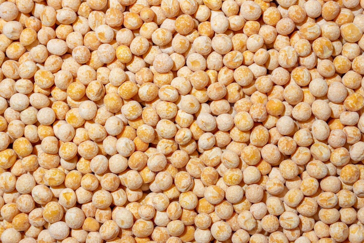 Uncooked Yellow Polished Peas Background. A Culinary Canvas of Dry Yellow Peas, Creating a Lively and Textured Background for Gourmet Cooking. Scattered Raw Polished Peas. Healthy Eating Ingredients photo