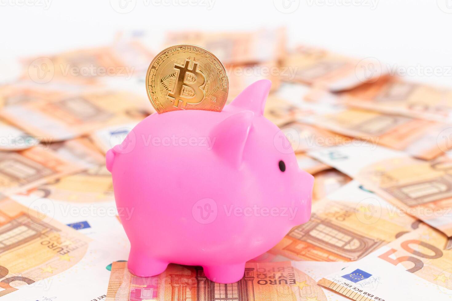 Pink Piggy Bank with Bitcoin Coin on the Fifty Euro Banknotes. Small Money Box for Cash and Coins. Money Saving Concept photo