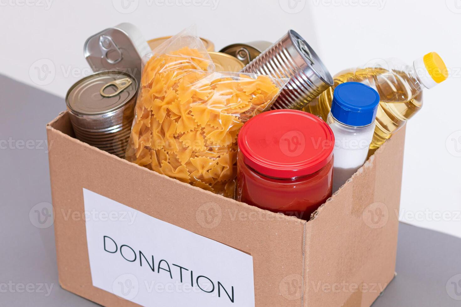 Donation Box of Free Food. Carton Box with Canned Food, Cereals and Grocery. Meal Reserves. Emergency Food Storage in Case of Crisis. Free Social Help, Blessings and Care. Strategic Food Supplies photo