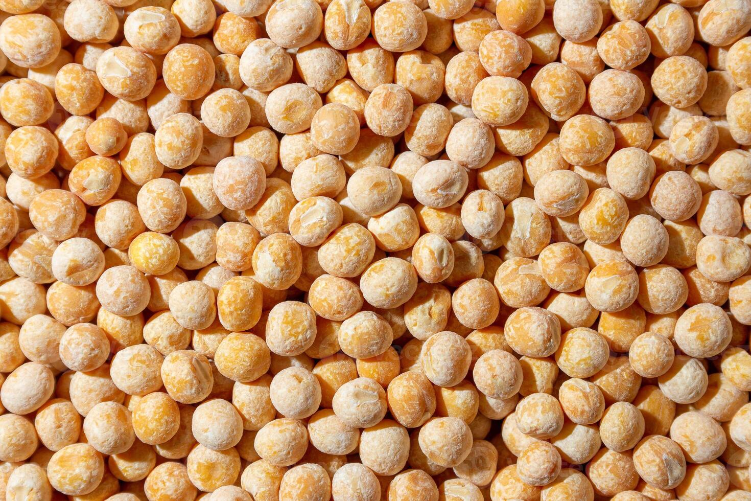 Uncooked Yellow Polished Peas Background. A Culinary Canvas of Dry Yellow Peas, Creating a Lively and Textured Background for Gourmet Cooking. Scattered Raw Polished Peas. Healthy Eating Ingredients photo
